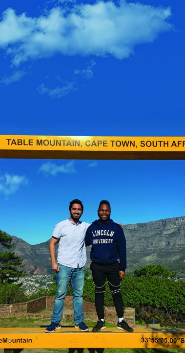 Two Internship students standing in front of Table Mountain in Cape Town