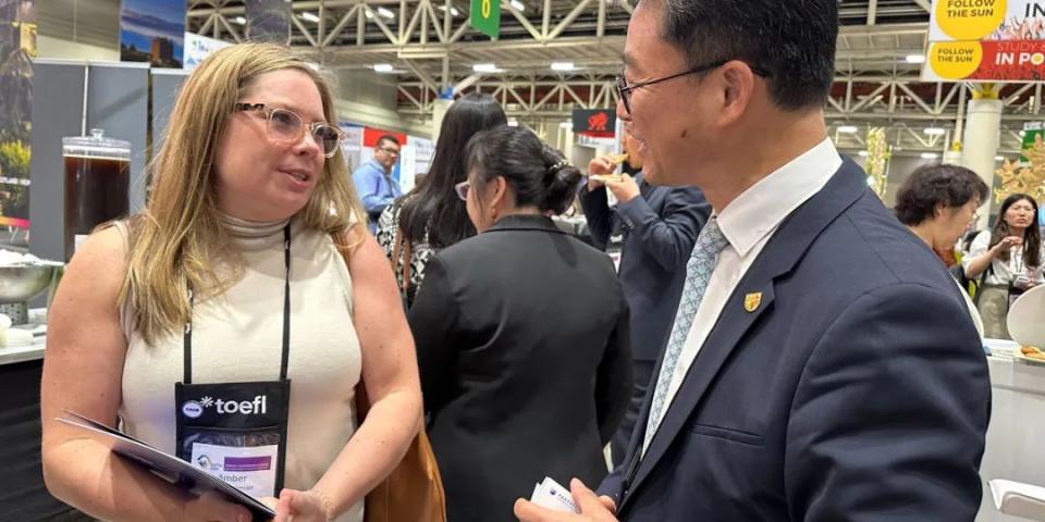 Two people chatting and smiling at NAFSA 2024